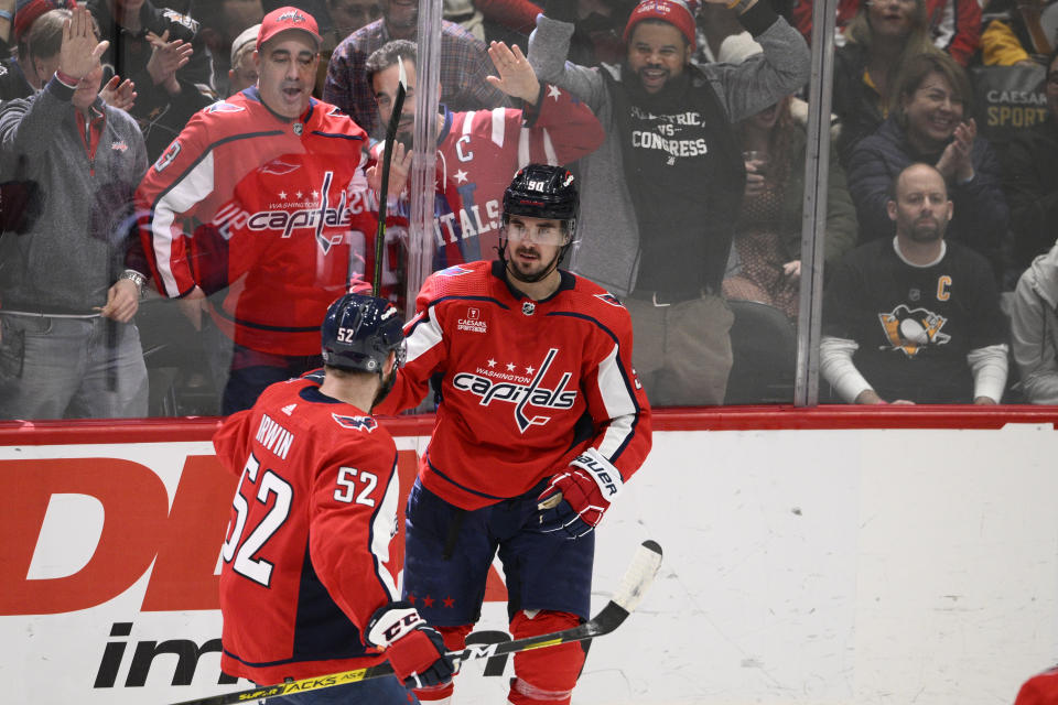Washington Capitals left wing Marcus Johansson (90) celebrates his goal against the Pittsburgh Penguins with defenseman Matt Irwin (52) during the third period of an NHL hockey game Thursday, Jan. 26, 2023, in Washington. The Capitals won 3-2 in a shootout. (AP Photo/Nick Wass)