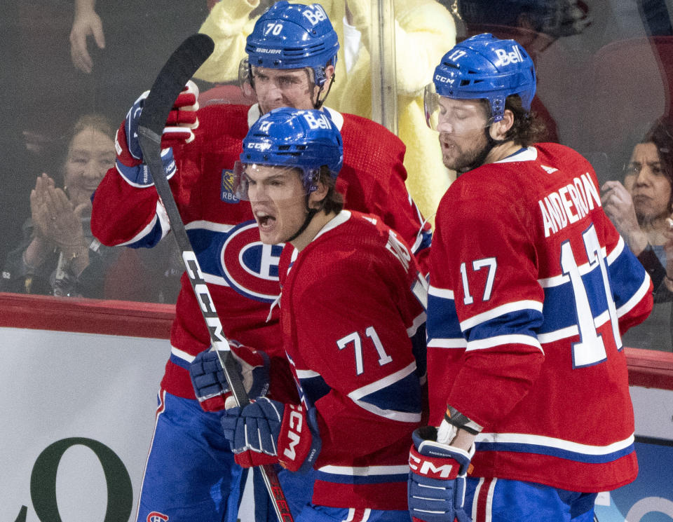 Montreal Canadiens' Jake Evans (71) celebrates his goal against the Anaheim Ducks with Tanner Pearson (70) and Josh Anderson (17) during the second period of an NHL hockey game Tuesday, Feb. 13, 2024, in Montreal. (Christinne Muschi/The Canadian Press via AP)