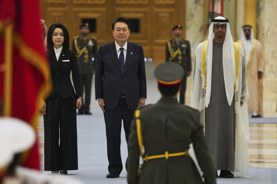 From left, South Korean first lady Kim Keon Hee, South Korean President Yoon Suk Yeol and Emirati leader Sheikh Mohammed bin Zayed Al Nahyan attend a ceremony at Qasar Al Watan in Abu Dhabi, United Arab Emirates, Sunday, Jan. 15, 2023. Yoon received an honor guard welcome Sunday on a trip to the United Arab Emirates, where Seoul hopes to expand its military sales while finishing its construction of the Arabian Peninsula's first nuclear power plant. (AP Photo/Jon Gambrell)