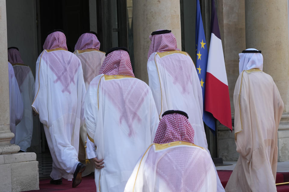 Members of the Saudi delegation enter the Elysee Palace before Saudi Crown Prince Mohammed bin Salman's arrival Friday, June 16, 2023 in Paris. Saudi Crown Prince Mohammed bin Salman is to meet with French President Emmanuel Macron as part of an official visit, during which he will also participate in a global financing summit aimed at fighting poverty and climate change. (AP Photo/Michel Euler)
