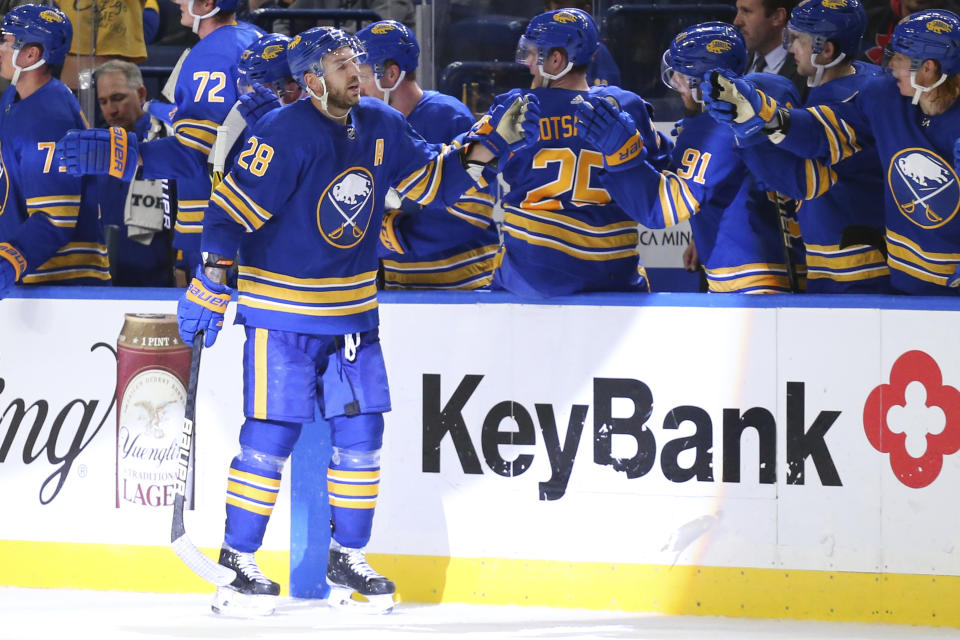 Buffalo Sabres forward Zemgus Girgensons (28) is congratulated for his goal during the second period of the team's NHL hockey game against the Vancouver Canucks, Tuesday, Oct. 19, 2021, in Buffalo, N.Y. (AP Photo/Jeffrey T. Barnes)