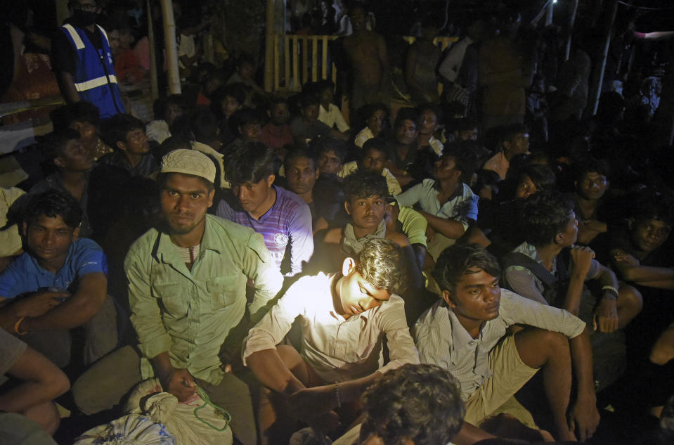 Ethnic Rohingya people rest after the boat carrying them landed in Lhokseumawe, Aceh province, Indonesia, early Monday, Sept. 7, 2020. Almost 300 Rohingya Muslims were found on a beach in Indonesia's Aceh province Monday and were evacuated by military, police and Red Cross volunteers, authorities said. (AP Photo/Rahmat Mirza)