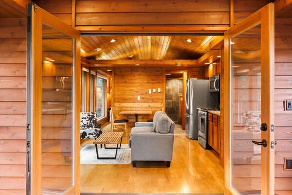 One of Escape’s models at its new tiny home village, The Oaks, in Tampa Bay, Florida, features double doors and a generous amount of wood cladding.