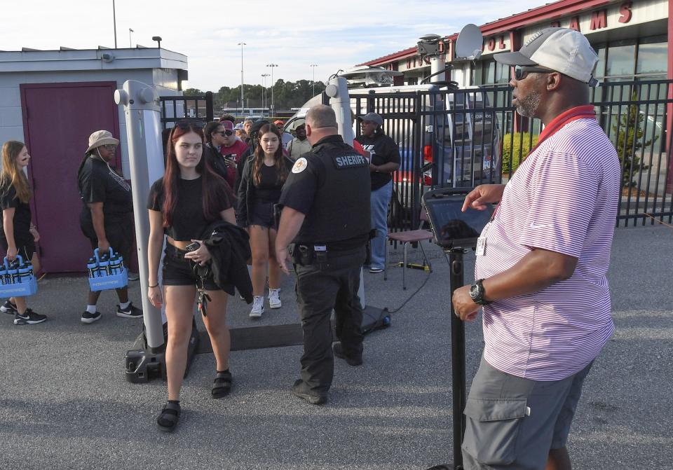 Security check with metal detector with fans entering before the game between TL Hanna High and Westside High School in Anderson, S.C. Friday, September 1, 2023.
