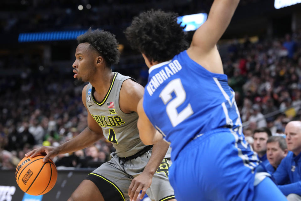 Baylor guard LJ Cryer, back, steps away from Creighton guard Ryan Nembhard during the first half of a second-round college basketball game in the men's NCAA Tournament on Sunday, March 19, 2023, in Denver. (AP Photo/David Zalubowski)