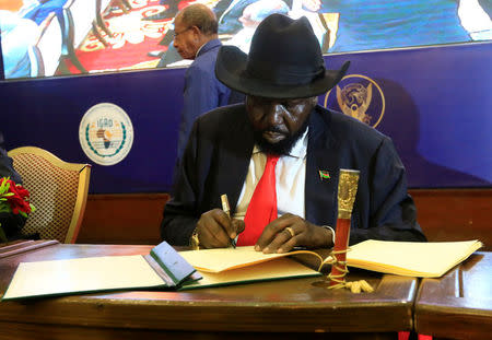 South Sudan's President Salva Kiir signs of a cease fire and power sharing agreement with South Sudan's rebel leader Riek Machar in Khartoum, Sudan August 5, 2018. REUTERS/Mohamed Nureldin Abdallah