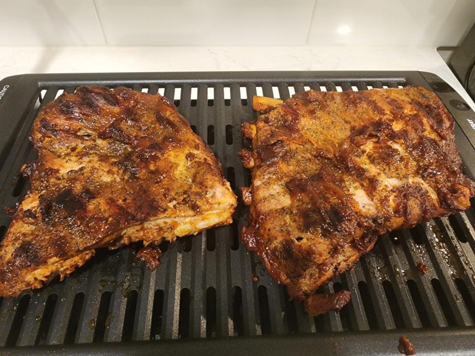 two racks of ribs on a grill pan