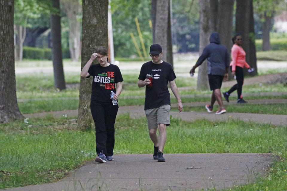 Walkers and runners take advantage of the 1-mile Parham Bridges walking track, Monday, March 23, 2020, in Jackson, Miss. Runners across the country are still hitting the pavement and the trails, staying fit and working off some stress amid the coronavirus pandemic. (AP Photo/Rogelio V. Solis)