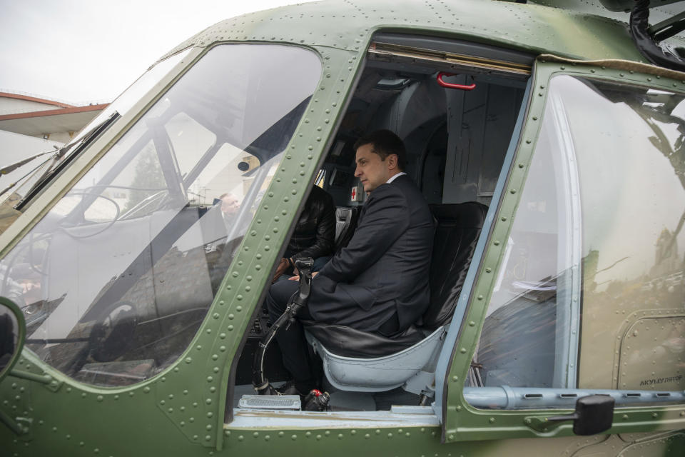 In this handout photo provided by the Ukrainian Presidential Press Office ,Ukrainian President Volodymyr Zelenskiy sits inside a military helicopter as he visits an arm exhibition in Kyiv, Ukraine, Wednesday, Oct. 9, 2019. (Ukrainian Presidential Press Office via AP)