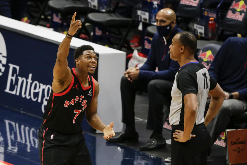 Toronto Raptor guard Kyle Lowry (7) discusses a call with referee Rodney Mott (71) during the first half of an NBA basketball game against New Orleans Pelicans on Saturday, Jan. 2, 2021, in New Orleans. (AP Photo/Butch Dill)