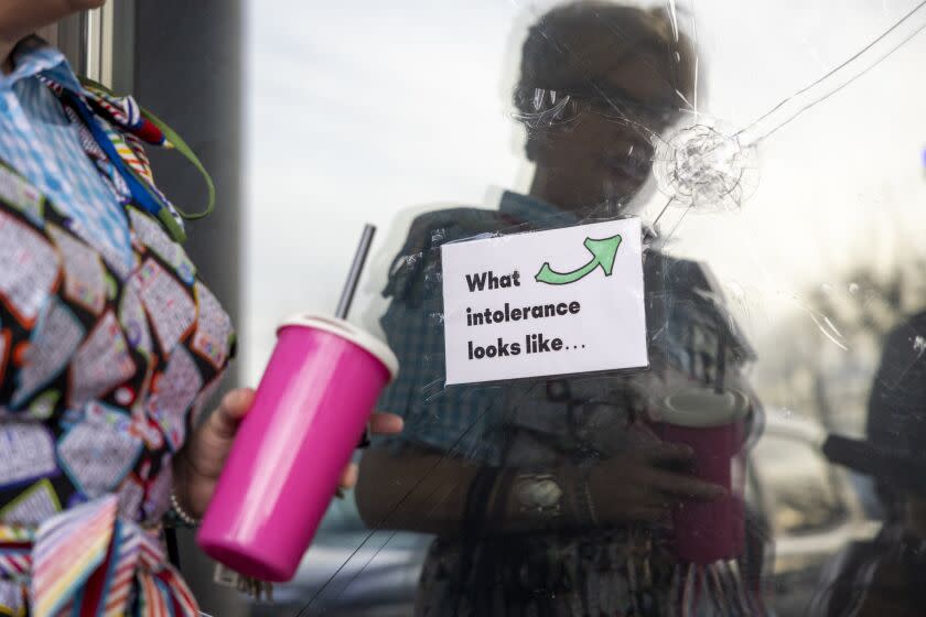 Drag Queen, Sylvia O'Stayformre, stops to talk about the damage from a December 7 incident, when someone fired a steel ball into the front window, as she arrives to host Drag Queen Storytime and Bingo at Brewmaster's Tap Room in Renton, Wash. on Saturday, Jan. 14, 2023.