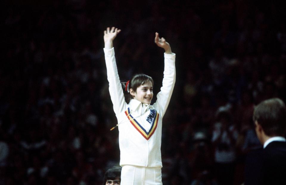 <p>At 14 years old, Nadia Comaneci earned the first perfect-10 in an Olympic gymnastic event. She won three gold medals in these games, changing the nature of the sport forever. (Getty) </p>