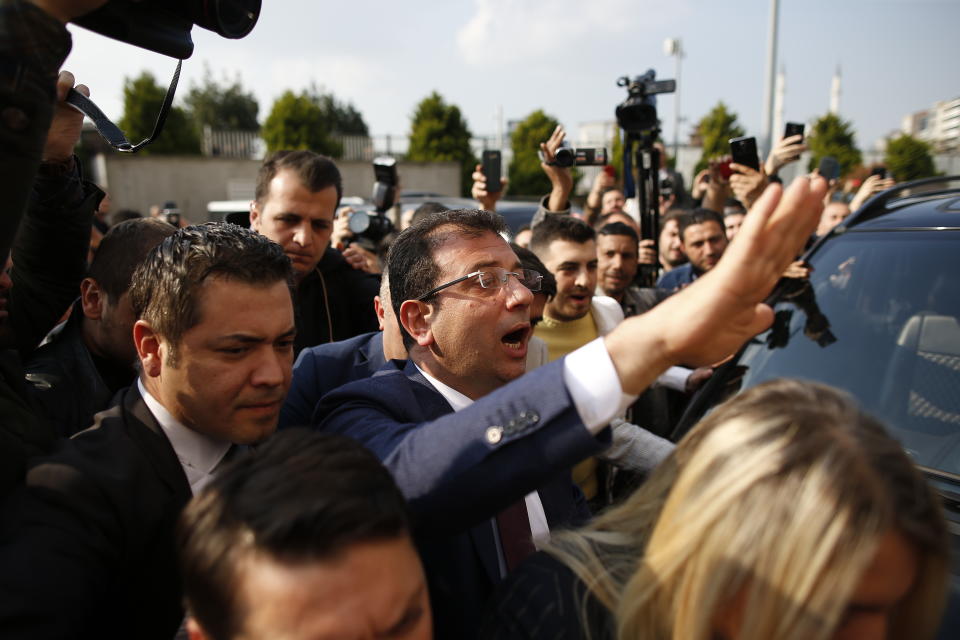 Ekrem Imamoglu, centre, of the opposition Republican People's Party (CHP) mayoral candidate in Istanbul, arrives to receive a certificate confirming his win by a slim margin against ruling party's candidate Binali Yildirim, in Istanbul, Turkey, Wednesday, April 17, 2019. Authorities have confirmed that Imamoglu won the mayoral election in Istanbul, ending nearly three weeks of recounts, although Turkey's top electoral body, has yet to consider a ruling party request for the vote in Istanbul to be invalidated.(AP Photo/Emrah Gurel)