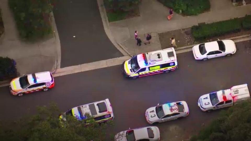 Emergency vehicles line the street outside the scene. Photo: ABC