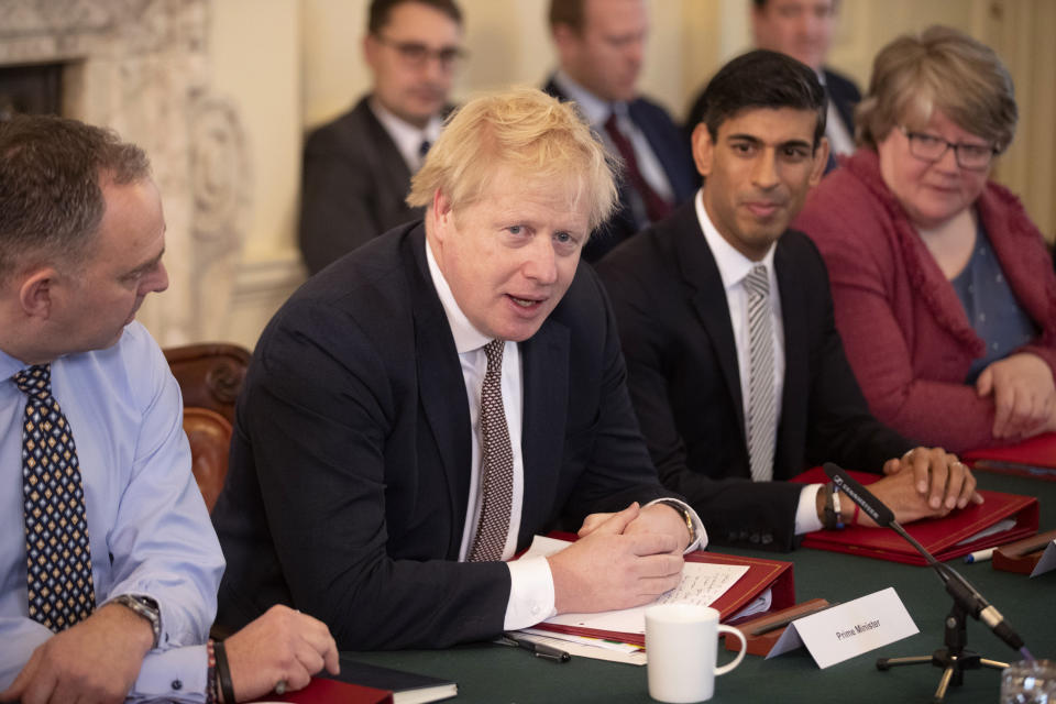 FILE - British Prime Minister Boris Johnson speaks during his first Cabinet meeting flanked by his new Chancellor of the Exchequer Rishi Sunak, centre right, after a reshuffle the day before, inside 10 Downing Street, in London, Feb. 14, 2020. Boris Johnson’s bluster couldn’t hide the facts: He didn’t have the votes to win the Conservative Party leadership contest and stage a political comeback just weeks after being forced out as prime minister. (AP Photo/Matt Dunham, Pool, File)