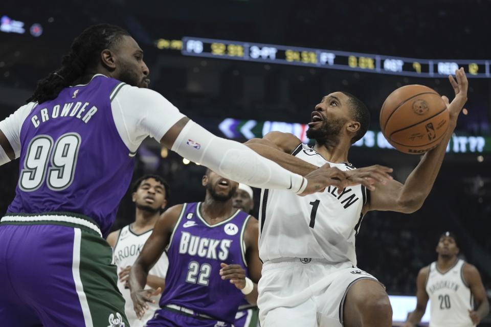 Milwaukee Bucks' Jae Crowder knocks the ball from Brooklyn Nets' Mikal Bridges during the first half of an NBA basketball game Thursday, March 9, 2023, in Milwaukee. (AP Photo/Morry Gash)