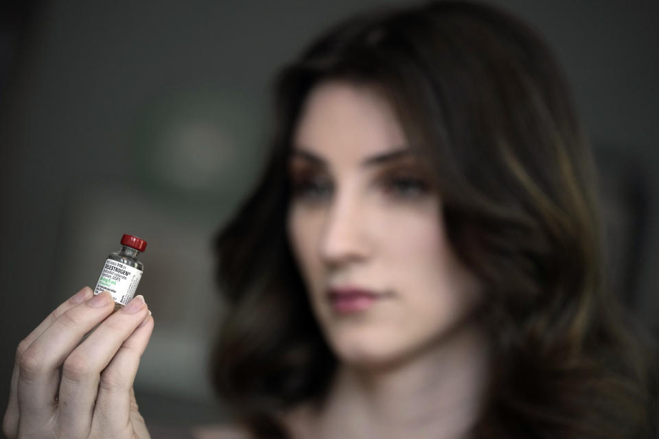 Transgender woman Stacy Cay displays some of the hormone therapy drugs she has stockpiled in fear of losing her supply, Thursday, April 20, 2023, at her home in Overland Park, Kan. (AP Photo/Charlie Riedel)