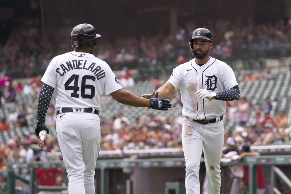 Detroit Tigers' Riley Greene celebrates after scoring with Jeimer Candelario (46) against the Cleveland Guardians in the first inning of a baseball game in Detroit, Monday, July 4, 2022. (AP Photo/Paul Sancya)