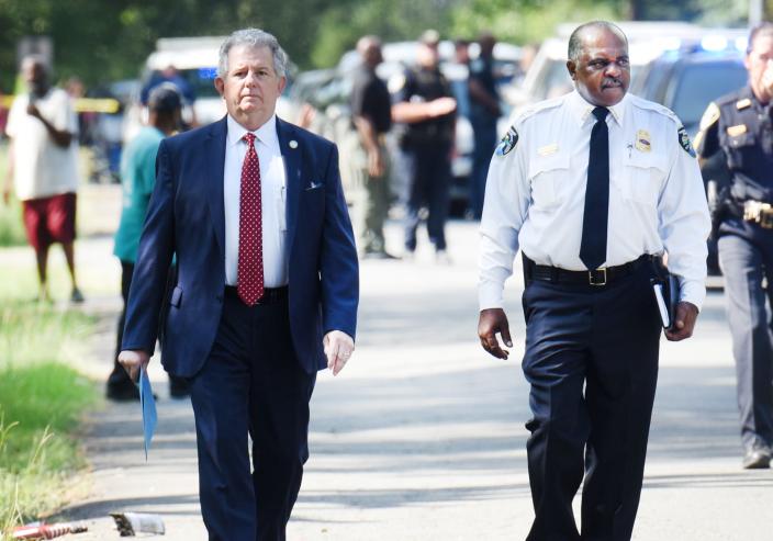 Shreveport's Mayor Tom Arceneaux, left, and Police Chief Wayne Smith walk down Jones Mabry Rd. Wednesday morning, July 5, 2023, which was the scene of a mass shooting at a 4th of July block party that resulted in 4 deaths and 11 injuries.  