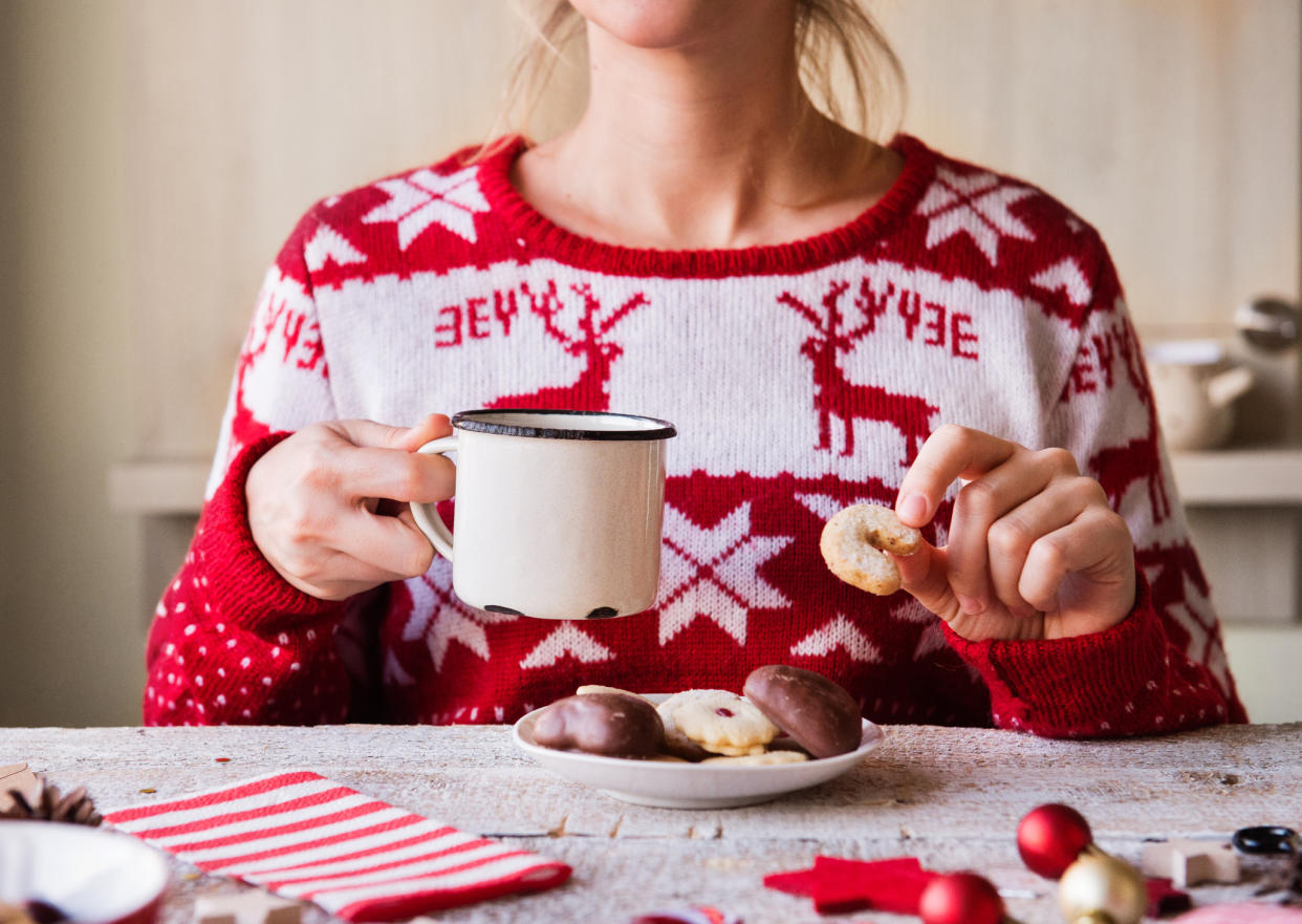 Woman enjoying sweet treats at Christmas, but how does it impact gut health? (Getty Images)
