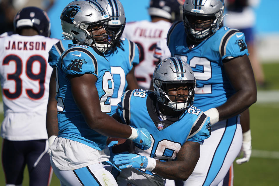 Carolina Panthers running back Mike Davis (28) and tight end Chris Manhertz, left, celebrate Davis' touchdown against the Chicago Bears during the second half of an NFL football game in Charlotte, N.C., Sunday, Oct. 18, 2020. (AP Photo/Brian Blanco)