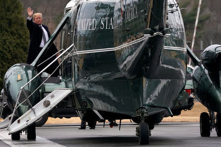 U.S. President Donald Trump waves from the steps of Marine One helicopter upon his departure after his annual physical exam at Walter Reed National Military Medical Center in Bethesda, Maryland, U.S., January 12, 2018. REUTERS/Yuri Gripas