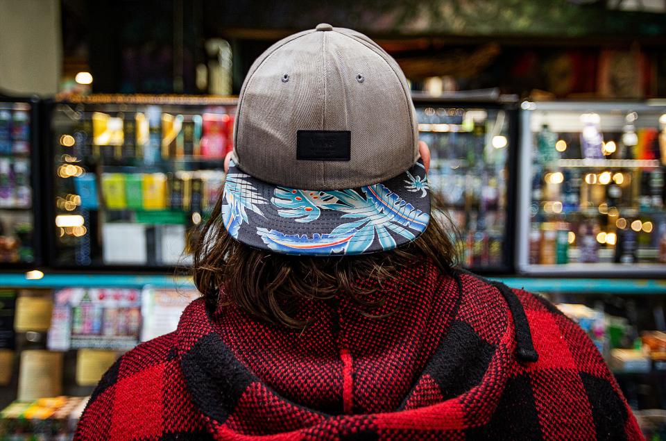 A college student who did not want to be named looked over the various delta-8 products in a display case at the Electric Ladyland store, located at 2325 Bardstown Road, on Jan. 19, 2023