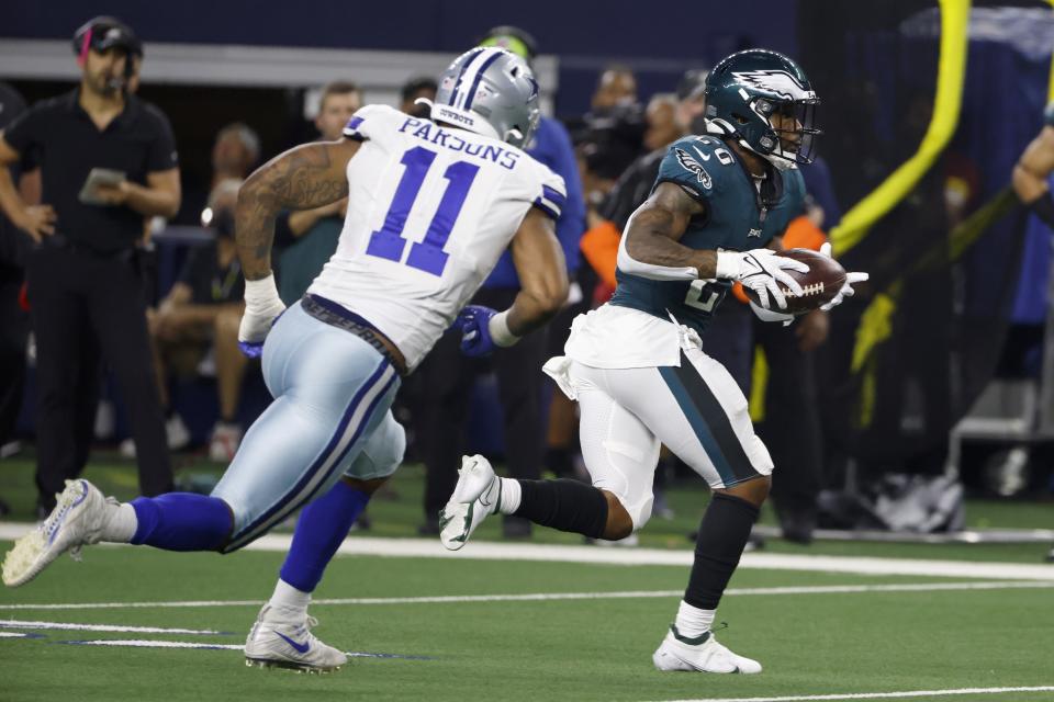 Dallas Cowboys linebacker Micah Parsons (11) gives chase as Philadelphia Eagles running back Miles Sanders (26) gains yardage after catching a pass in the second half of an NFL football game in Arlington, Texas, Monday, Sept. 27, 2021. (AP Photo/Ron Jenkins)