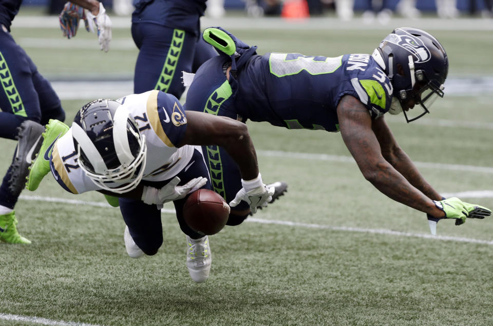 Los Angeles Rams wide receiver Brandin Cooks (12) is hit by Seattle Seahawks free safety Tedric Thompson, right, during the first half of an NFL football game, Sunday, Oct. 7, 2018, in Seattle. Cooks left the game with an injury after the play. (AP Photo/Elaine Thompson)