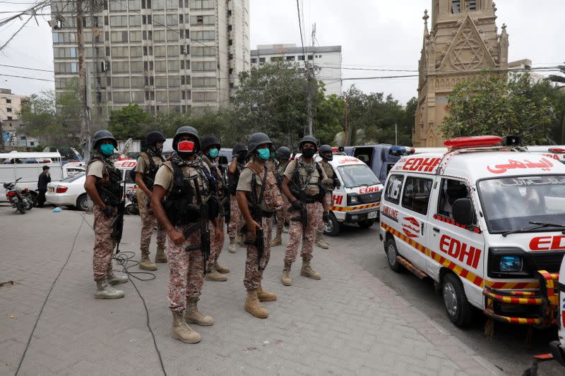 Paramilitary soldiers stand guard at the site of an attack at the Pakistan Stock Exchange in Karachi