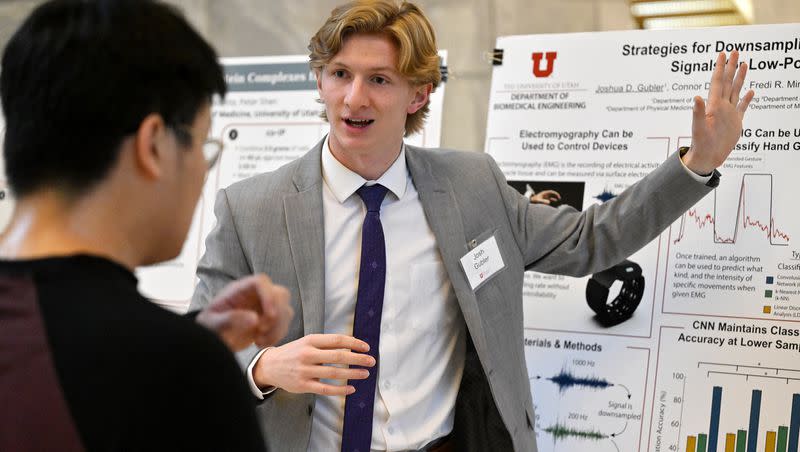 University of Utah graduate Angus Wu listens to Josh Gubler’s presentation about using electrical signals in the muscle to control devices as Utah and Utah State students present research ideas at the Capitol in Salt Lake City on Thursday, Jan. 18, 2024.