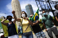 A group of demonstrators formed by former supporters of Brazil's President Jair Bolsonaro protest against the government's response in combating COVID-19 and demanding Bolsonaro's impeachment, in Rio de Janeiro, Brazil, Sunday, Jan. 24, 2021. (AP Photo/Bruna Prado)