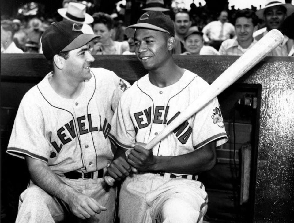 Manager Lou Boudreau and Larry Doby stand in the dugout at Comiskey Park in Chicago on July 5, 1947, the day Doby became the first black player in the American League.