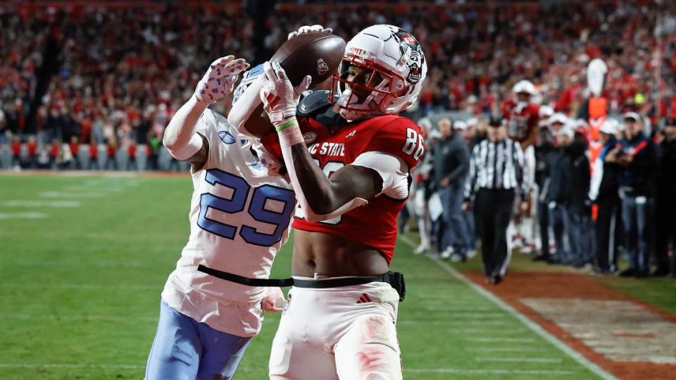 NC State’s Dacari Collins pulls in a touchdown pass against UNC’s Marcus Allen in the third quarter.