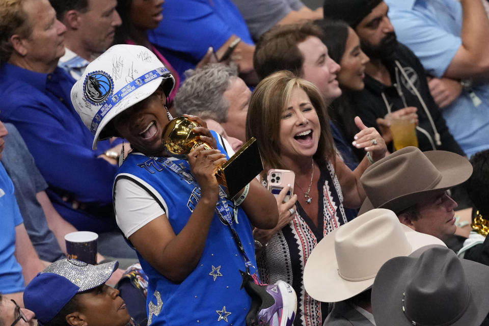 Fans celebrate during the second half in Game 4 of the NBA basketball finals between the Dallas Mavericks and the Boston Celtics, Friday, June 14, 2024, in Dallas. (AP Photo/Julio Cortez)