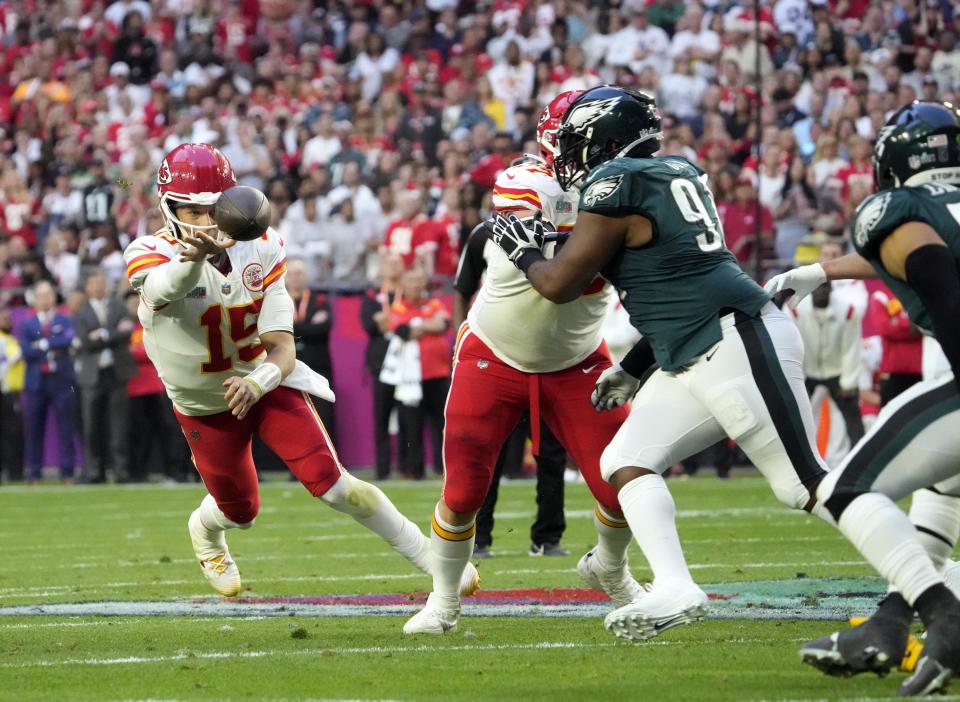 Kansas City Chiefs quarterback Patrick Mahomes (15) throws a pass as he is pressured by Philadelphia Eagles defensive tackle Fletcher Cox (91) during the first quarter in Super Bowl LVII in Glendale, Arizona, on Feb. 12.