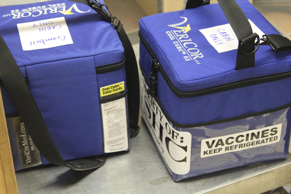 In this photo provided by Norton Sound Health Corp., are coolers containing Pfizer COVID-19 vaccines for the rural Alaska communities of Savoonga and Gambell being weighed at an air terminal in Nome, Alaska, on Jan. 14, 2021. Some of Alaska's highest vaccination rates among those 16 or older have been in some of its remotest, hardest-to-access communities, where the toll of past flu or tuberculosis outbreaks hasn't been forgotten. (Reba Lean/Norton Sound Health Corp. via AP)