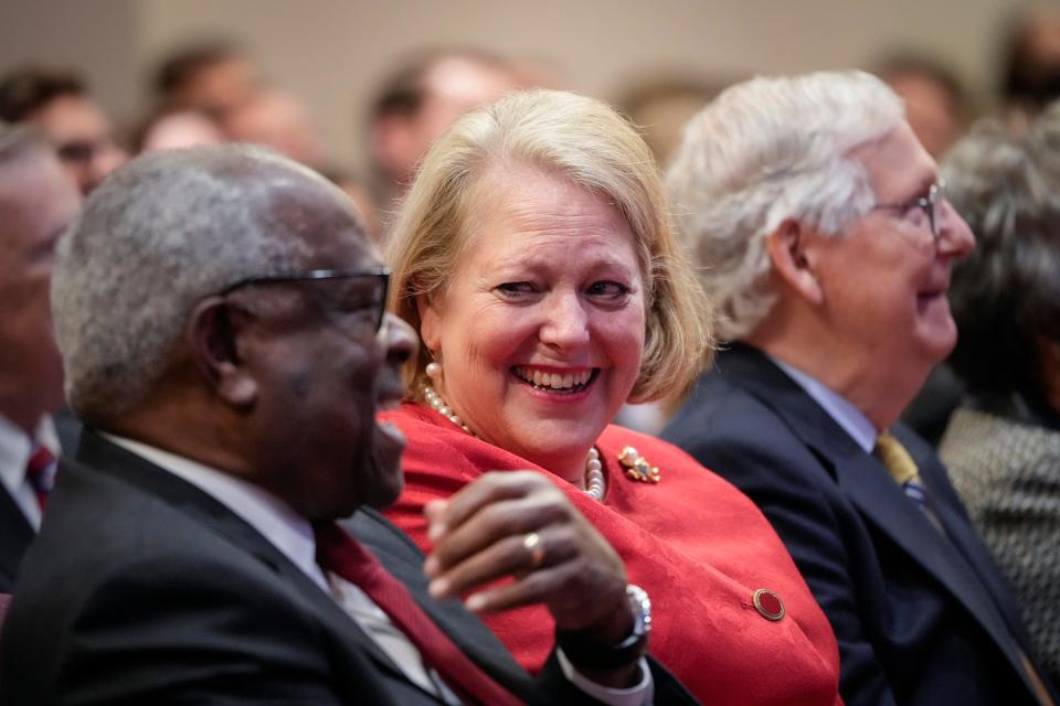 Associate Supreme Court Justice Clarence Thomas sits with his wife and conservative activist Virginia Thomas while he waits to speak at the Heritage Foundation on Oct. 21, 2021, in Washington, DC. They may have been laughing at the very idea that lavish vacations paid for by a wealthy Republican donor would ever influence Thomas' judicial decisions.