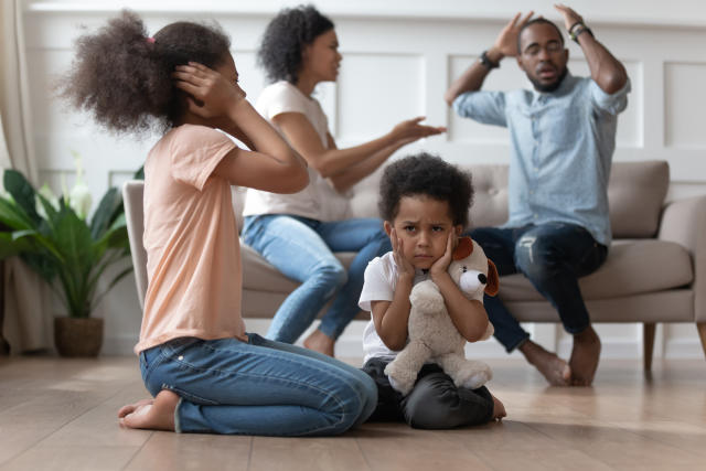 Upset african kids closing ears hurt by parents fighting arguing at home, sad stressed little innocent children suffer from family problems conflicts, unhappy mom dad shouting quarreling divorcing