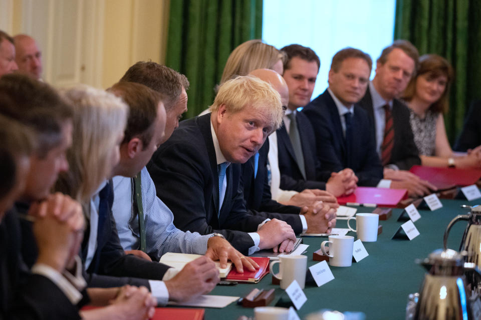 (from left, seated at table) Education Secretary Gavin Williamson, International Trade Secretary Liz Truss, Health and Social Care Secretary Matt Hancock, Cabinet Secretary Sir Mark Sedwill, Prime Minister Boris Johnson, Chancellor of the Exchequer Sajid Javid, Works and Pensions Secretary and Minister for Women Amber Rudd, Housing, Communities and Local Government Secretary Robert Jenrick, Transport Secretary Grant Shapps, Scottish Secretary Alister Jack and Culture Secretary Nicky Morgan, as Prime Minister Boris Johnson holds his first Cabinet meeting at Downing Street in London.