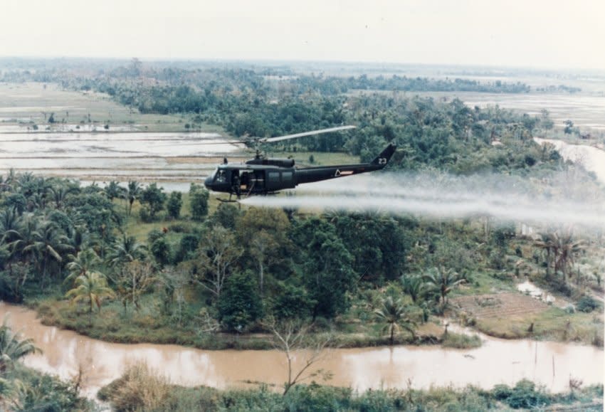 US Huey helicopter spraying Agent Orange in Vietnam