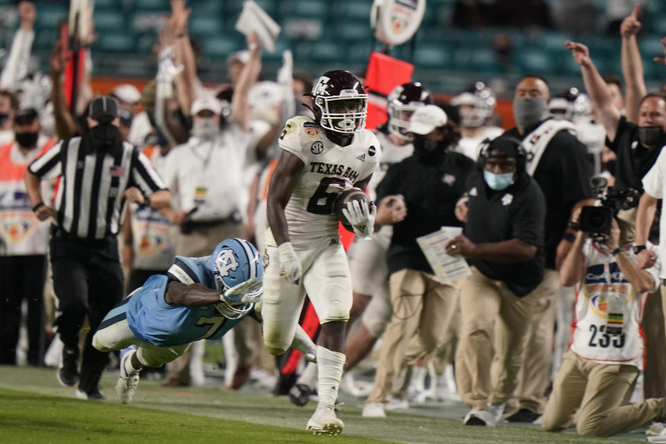 Texas A&M running back Devon Achane (6) runs for a touchdown during the second half of the Orange Bowl NCAA college football game, Saturday, Jan. 2, 2021, in Miami Gardens, Fla. Texas A&M defeated North Carolina 41-27. (AP Photo/Lynne Sladky)