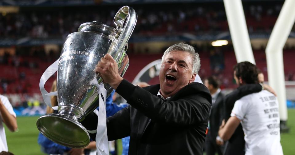 Carlo Ancelotti celebrates with the Champions League trophy after beating Atletico in the final at the Estadio da Luz, Lison, Portugal. May 24, 2014. Credit: Alamy