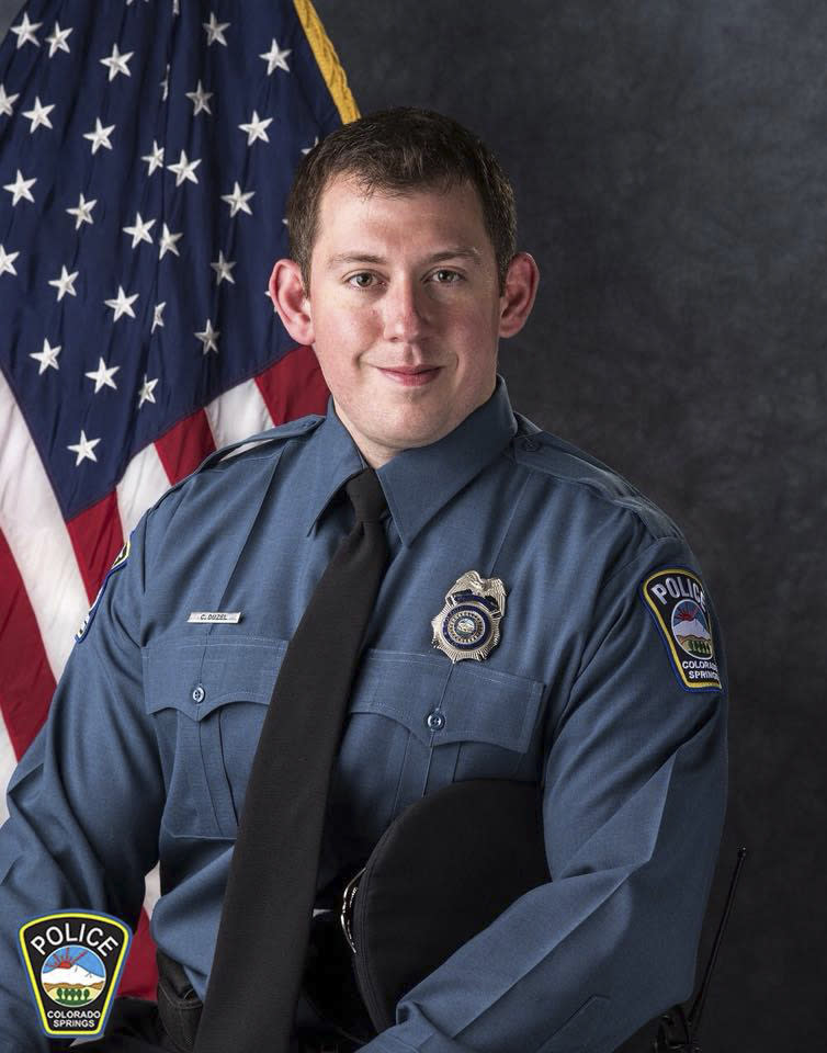 In this undated photo provided by Colorado Springs Police Department is Officer Cem Duzel. Police in Colorado Springs, Colo., said Monday, Aug. 6, 2018 that the officer who was wounded in a shootout was in “critical, but stable” condition. He was shot while responding to a call about shots fired early Thursday east of downtown. Investigators say 31-year-old Karrar Noaman Al Khammasi pulled a handgun and began shooting at officers. (Colorado Springs Police Department via AP)