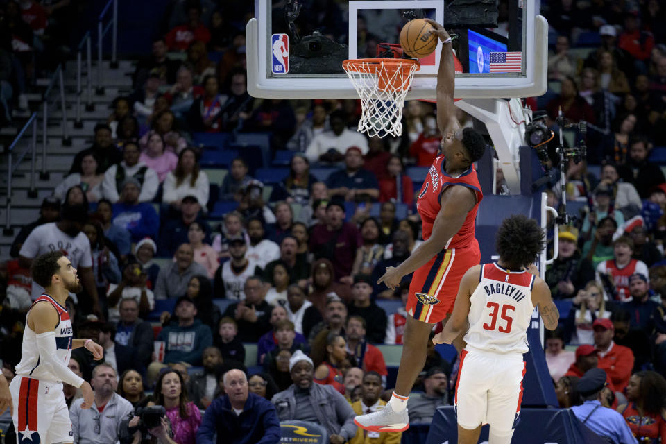 New Orleans Pelicans forward Zion Williamson (1) dunks over Washington Wizards forward Marvin Bagley III (35) during the second half of an NBA basketball game in New Orleans, Wednesday, Feb. 14, 2024. (AP Photo/Matthew Hinton)