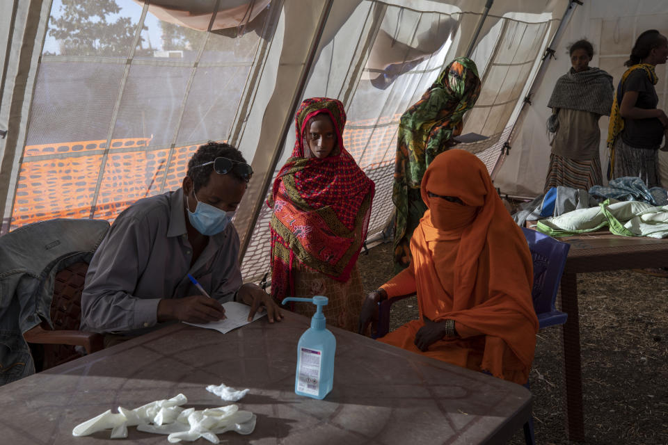 Tigray refugees who fled a conflict in the Ethiopia's Tigray region, receive treatment at a clinic run by MSF (Doctors Without Borders) in Village 8, the transit center near the Lugdi border crossing, eastern Sudan, Tuesday, Dec. 8, 2020. (AP Photo/Nariman El-Mofty)