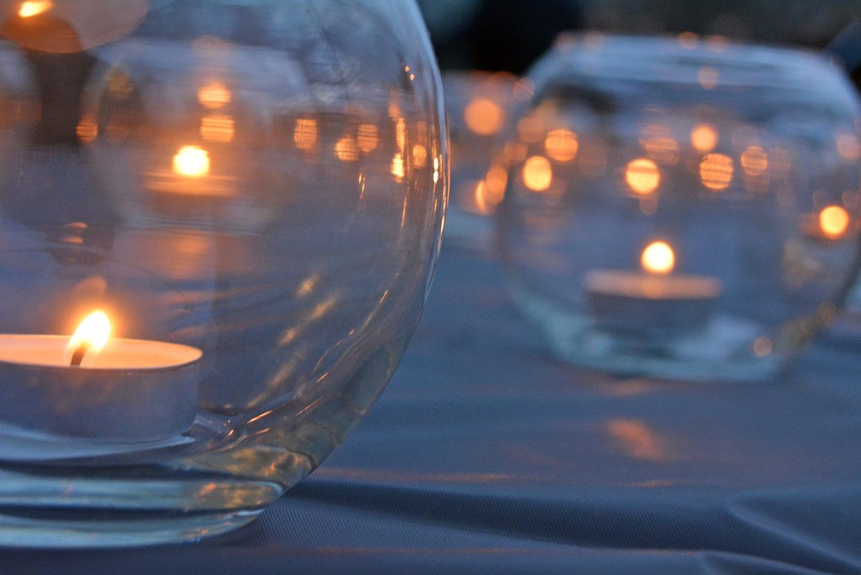 Tea lights on a table at the Salvation Army Harbor House in Columbia represent the 23 unsheltered residents who died over the last year.