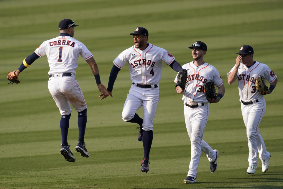 Houston Astros' Carlos Correa, from left, celebrates with George Springer, Kyle Tucker and Myles Straw after the Astros defeated the Oakland Athletics in Game 4 of a baseball American League Division Series in Los Angeles, Thursday, Oct. 8, 2020. (AP Photo/Ashley Landis)