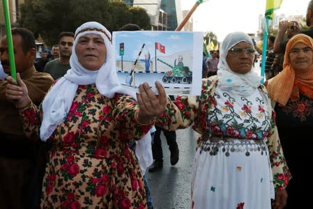 Kurds protest the Turkish offensive against Syria during a demonstration in Sulaimaniyah