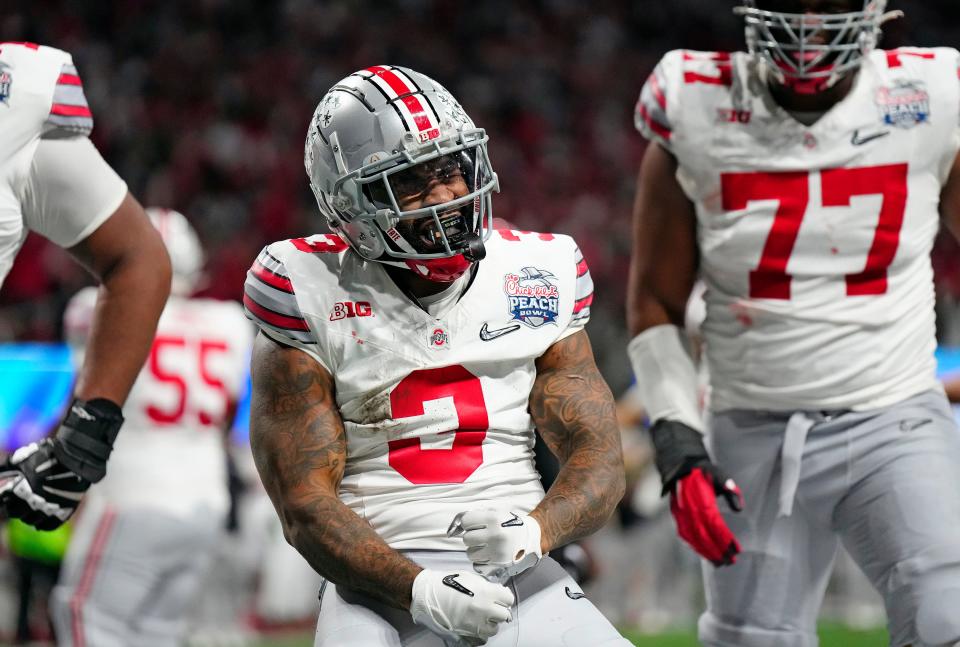 Dec 31, 2022; Atlanta, Georgia, USA; Ohio State Buckeyes running back Miyan Williams (3) celebrates a rushing touchdown against Georgia Bulldogs during the second quarter of the Peach Bowl in the College Football Playoff semifinal at Mercedes-Benz Stadium. 